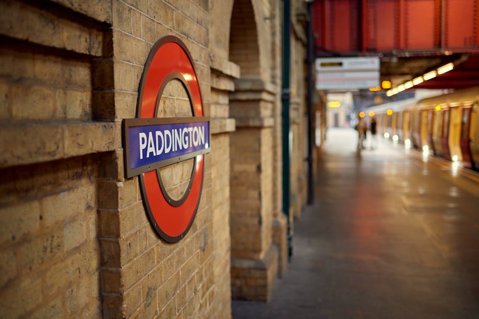 A rectangular white street sign mounted on a red brick wall, displaying the text 'Welcome to South Kensington' with 'South Kensington' in large black letters and 'SW7' in red font at the bottom right 